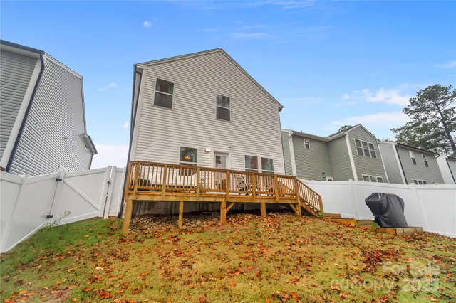 a view of a house with a bed and wooden fence