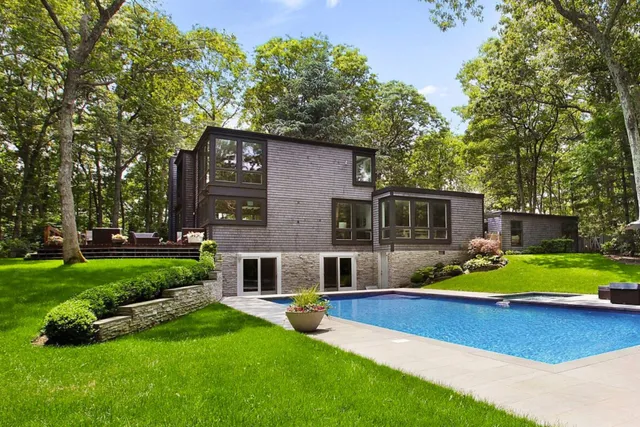 a front view of house with yard and outdoor seating