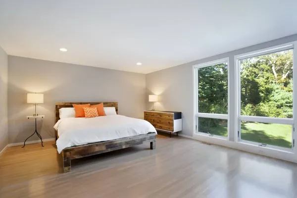 a spacious bedroom with a bed and a large window