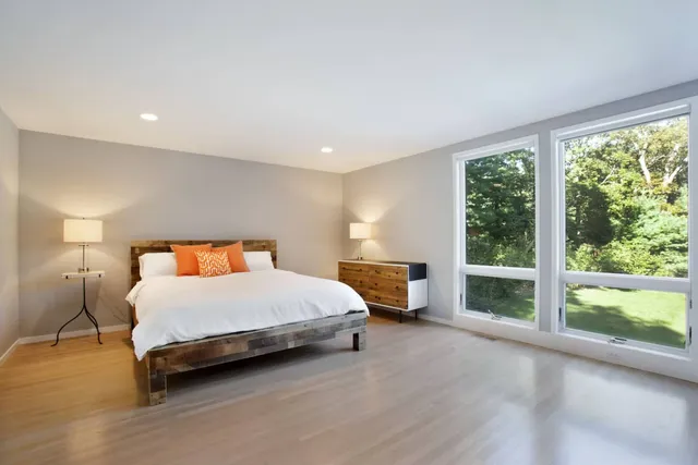 a spacious bedroom with a bed and a large window