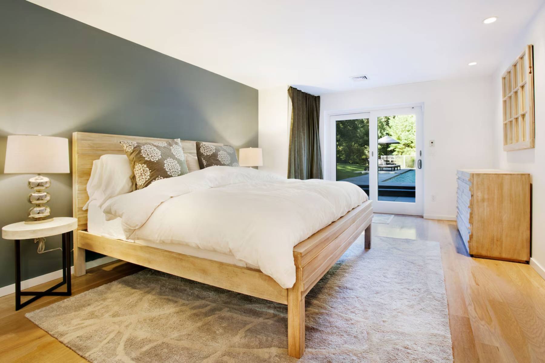 1006 Head Of Pond Road Water Mill, NY 11976 - Photo 14 of 18 a bed sitting in a spacious bedroom next to a window