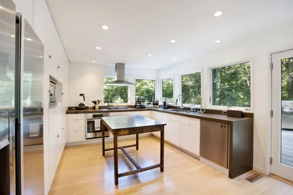 a kitchen with stainless steel appliances granite countertop counter space and a refrigerator