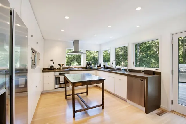 a kitchen with stainless steel appliances granite countertop counter space and a refrigerator