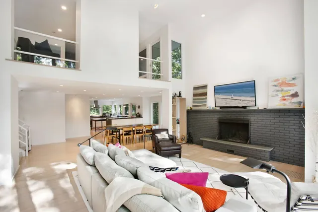 a living room with furniture fireplace and flat screen tv