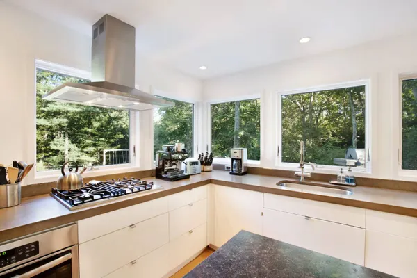 a kitchen with sink and large window