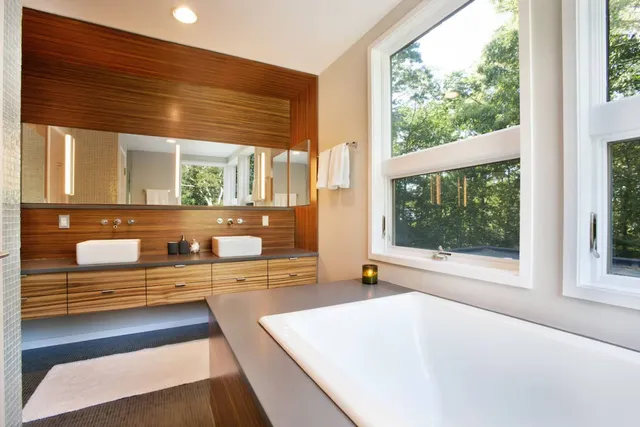a bathroom with a bathtub and next to a window