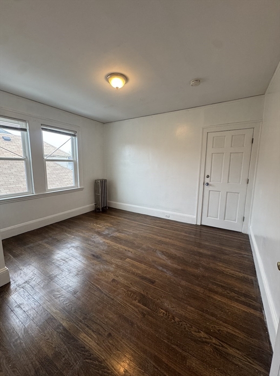127 St Andrew Road, Unit 2 Boston, MA 02128 - Photo 11 of 15 an empty room with wooden floor and windows