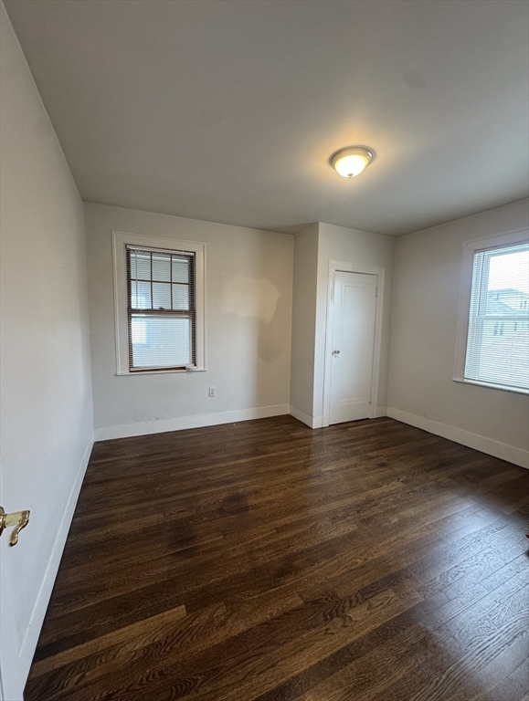 127 St Andrew Road, Unit 2 Boston, MA 02128 - Photo 9 of 15 an empty room with wooden floor and windows