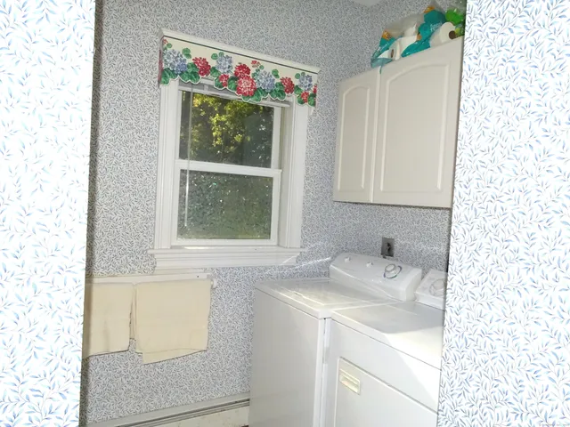 a large kitchen with granite countertop a stove a sink a dining table and chairs