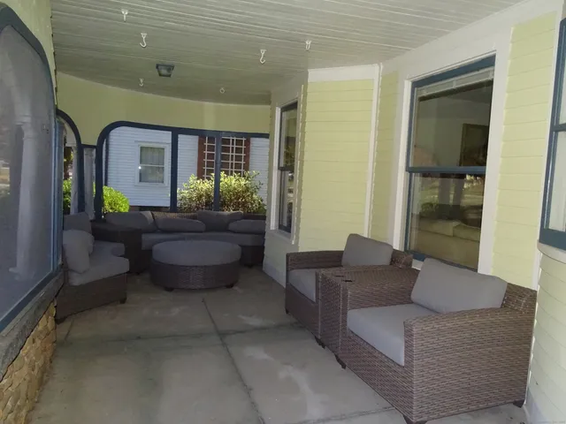 a view of a livingroom with furniture and a window