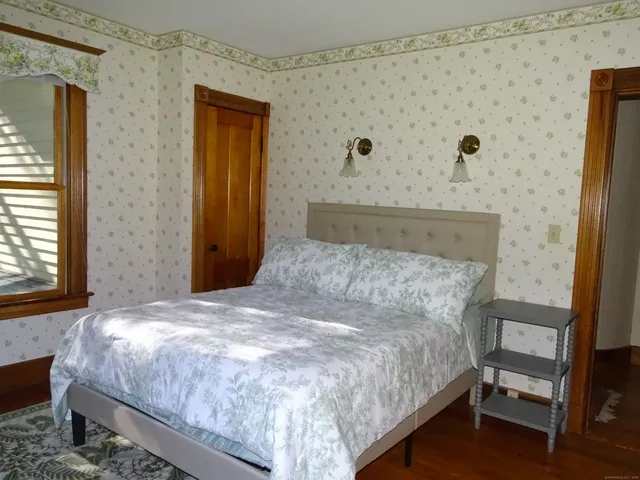 a bedroom with a bed and a flat tv screen