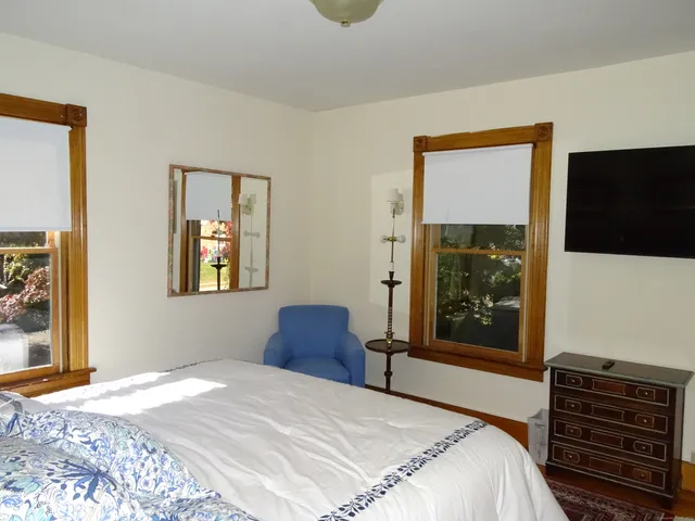 a bedroom with a bed and a couch