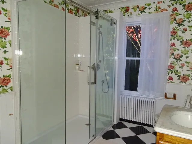 a bed sitting in a bedroom next to a small window