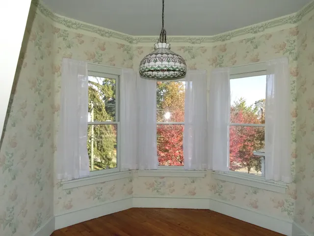 a view of a workspace with furniture and a window