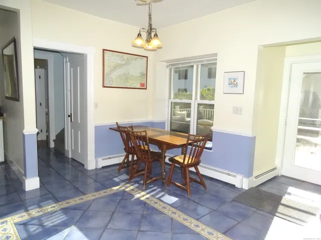 a picture of a rug with a white wall and picture