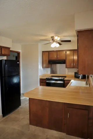 a kitchen with kitchen island a sink stainless steel appliances and cabinets