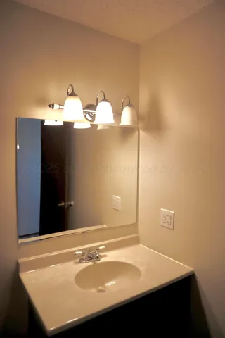 a view of a room with an empty space and a ceiling fan