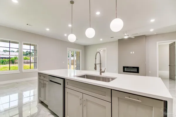 a kitchen with a sink and a large window