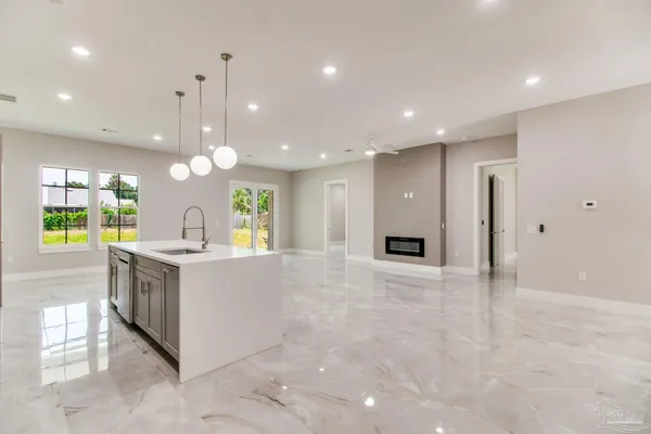 a large kitchen with a large counter top and stainless steel appliances