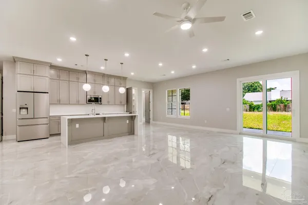a large white kitchen with a large window