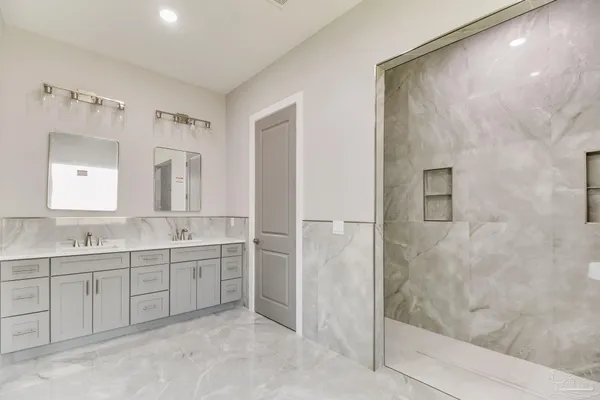 a bathroom with a double vanity sink and mirror