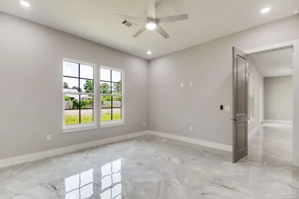 a white bath tub sitting in a bathroom next to a window