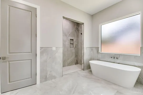 a bathroom with a bathtub and mirror
