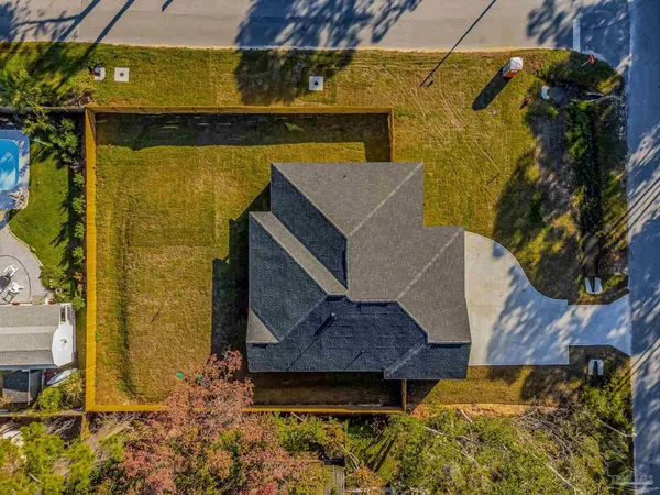 an aerial view of a house with a swimming pool
