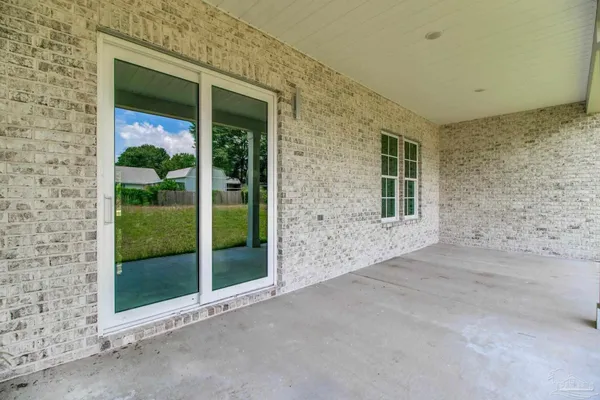 a view of a brick house with a large window