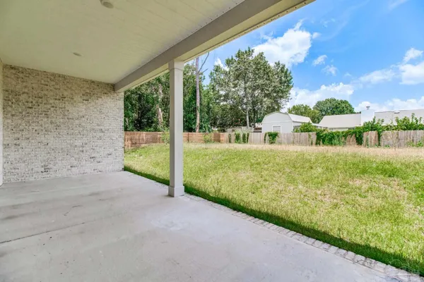 a view of a house with backyard and porch