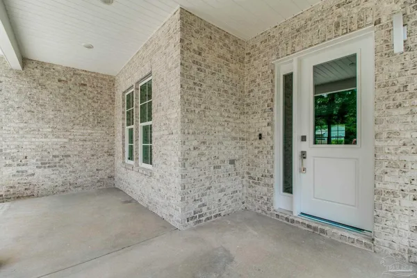 front view of a house with a brick wall