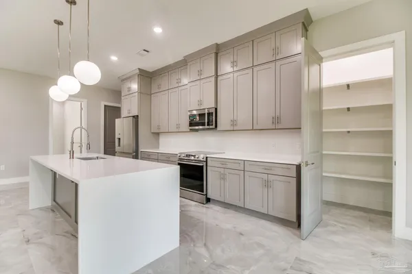 a kitchen with cabinets and white stainless steel appliances