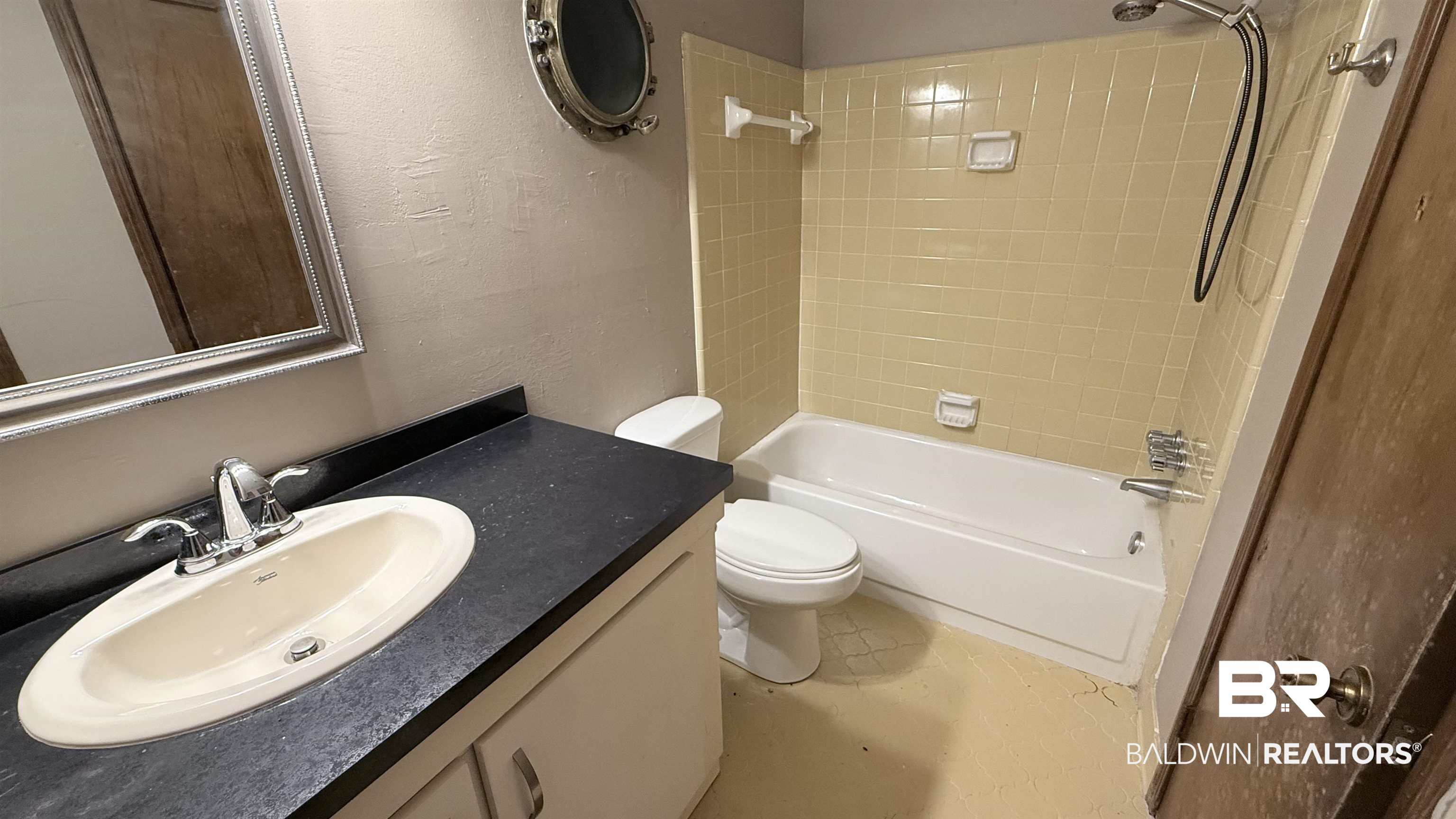 4131 Springdale Road Mobile, AL 36609 - Photo 15 of 28 Bathroom featuring a textured wall, washtub / shower combination, and vanity