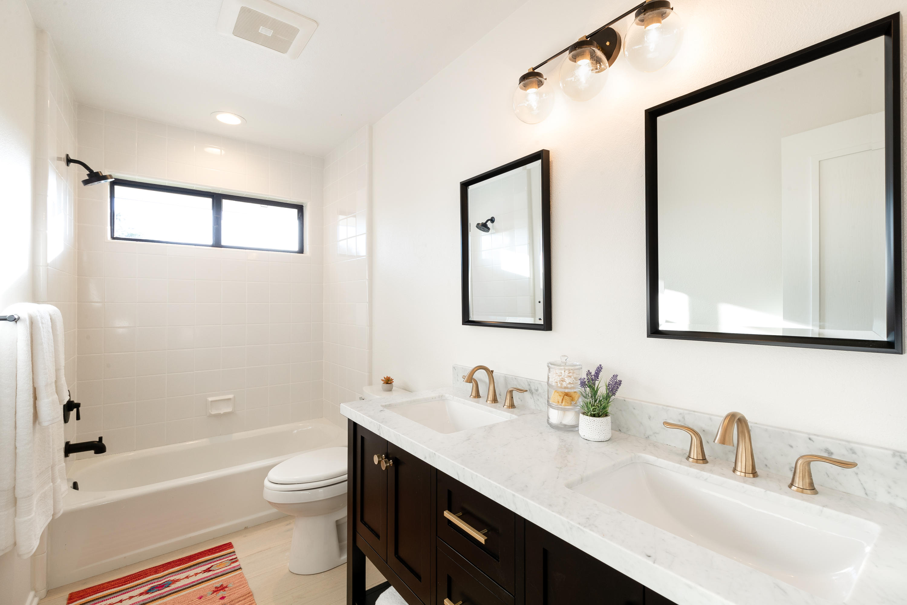 4671 La Espada Drive Santa Barbara, CA 93111 - Photo 23 of 37 a bathroom with a toilet a sink a bathtub and a mirror