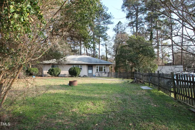 a view of a garden with a bench under an umbrella
