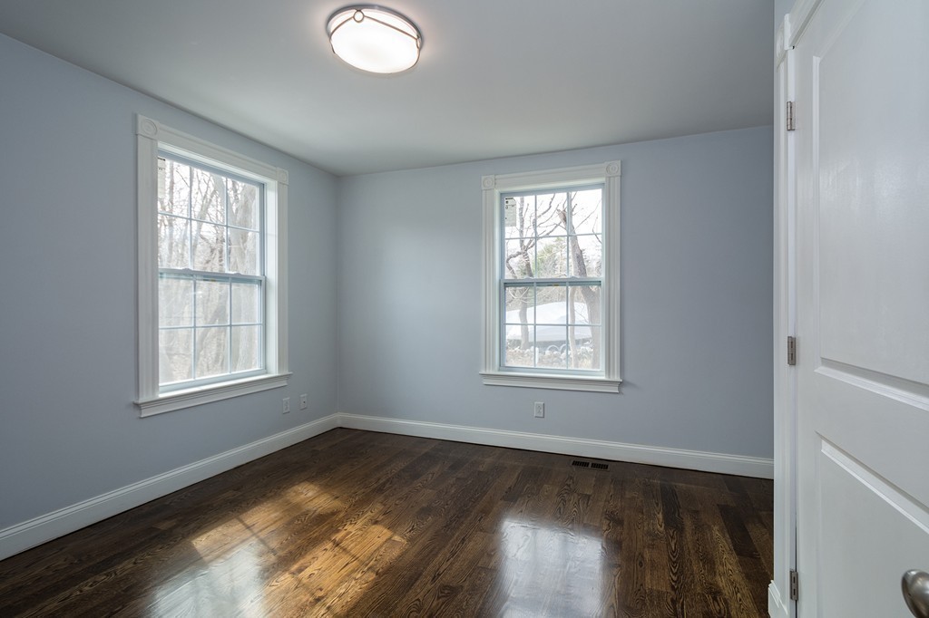 201 Beaver Dam Road Scituate, MA 02066 - Photo 12 of 21 a view of an empty room with wooden floor and a window