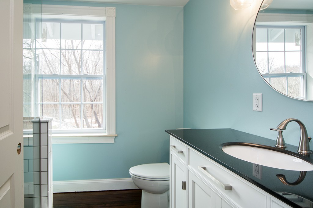 201 Beaver Dam Road Scituate, MA 02066 - Photo 13 of 21 a bathroom with a granite countertop toilet a sink and a window