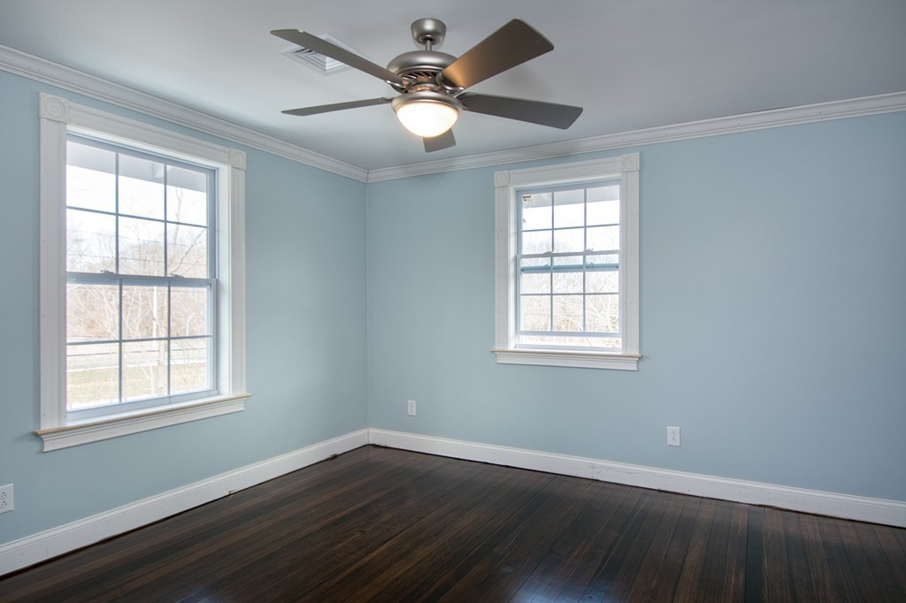 201 Beaver Dam Road Scituate, MA 02066 - Photo 14 of 21 a view of an empty room with wooden floor and a window