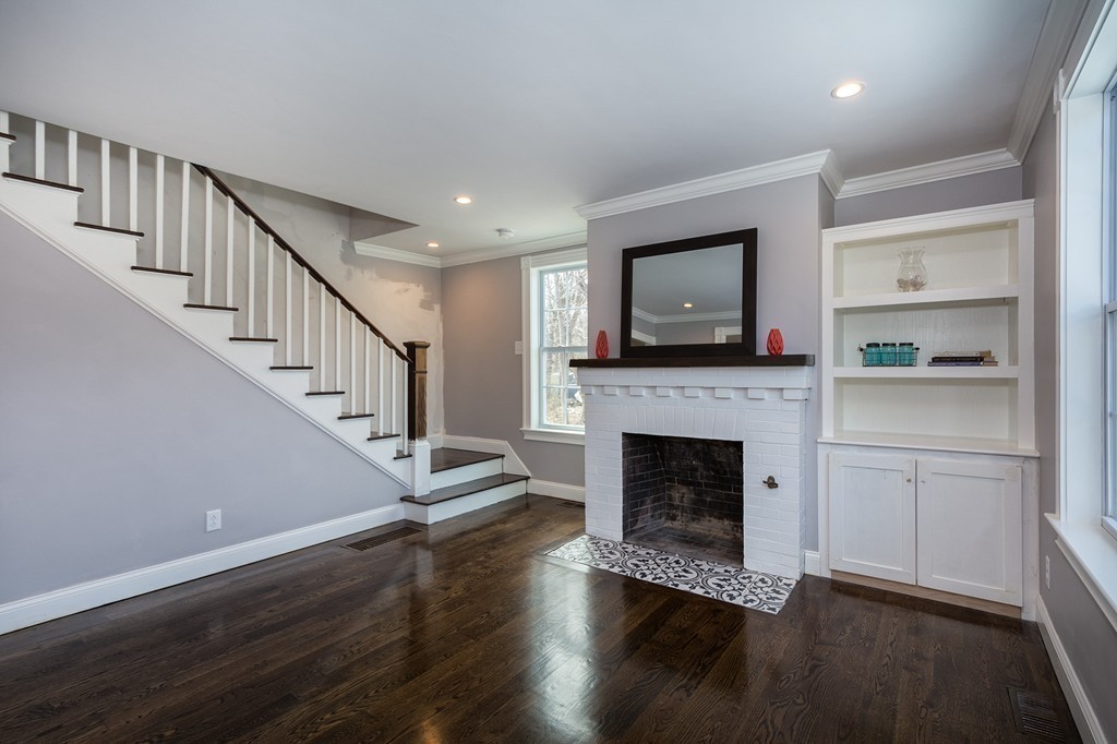 201 Beaver Dam Road Scituate, MA 02066 - Photo 7 of 21 a living room with wooden floors and fireplace