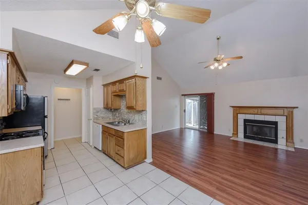 a view of kitchen with granite countertop cabinets and flat screen tv