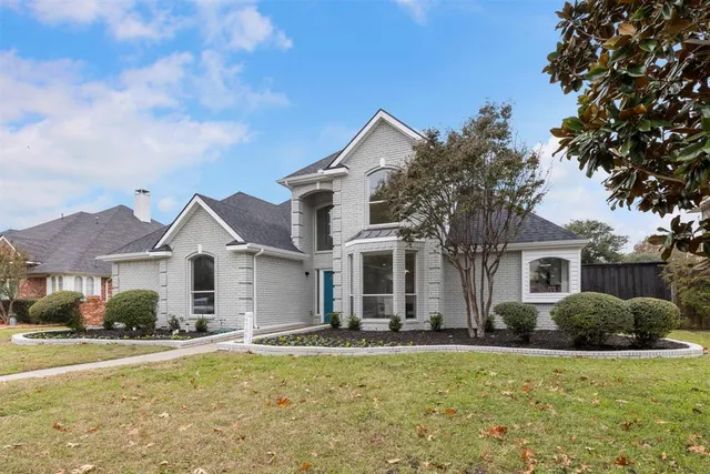 a front view of house with yard and trees around