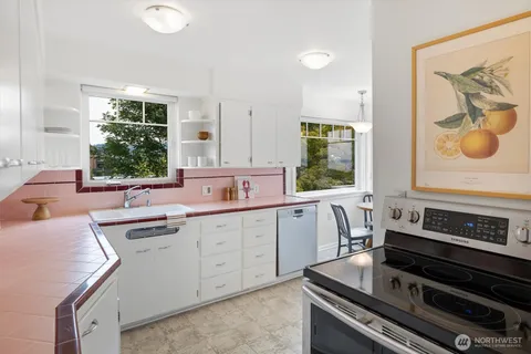 a kitchen with a stove a sink and a window