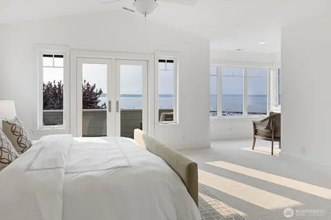 a bedroom with a bed and a view of living room