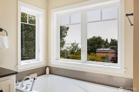 a bathroom with a bathtub and window