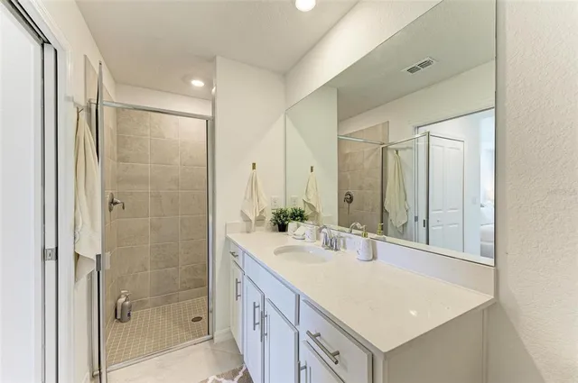 a bedroom with a bed and a ceiling fan