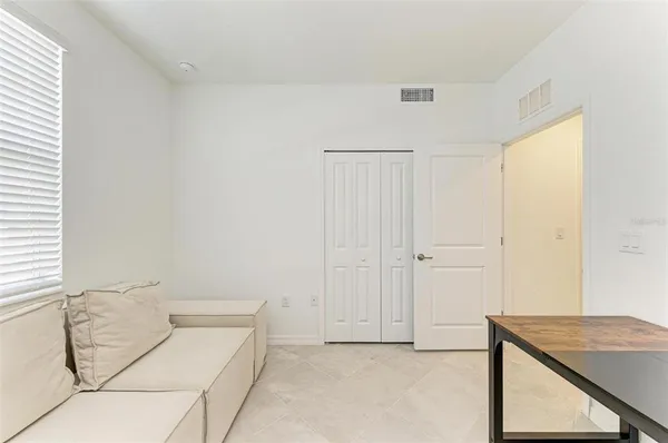 a bedroom with a large bed and ceiling fan