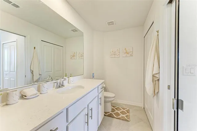 a bathroom with a granite countertop sink mirror and shower
