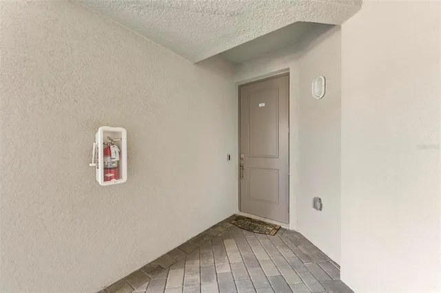 a view of a white house with a big yard and large trees