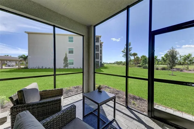 a swimming pool with an outdoor space and seating area