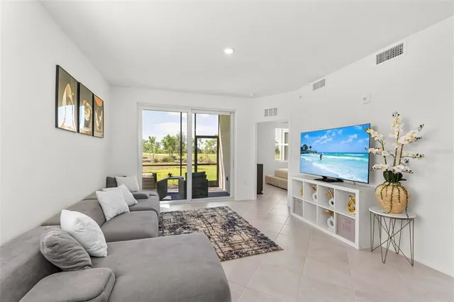 a kitchen with stainless steel appliances granite countertop a sink and a refrigerator